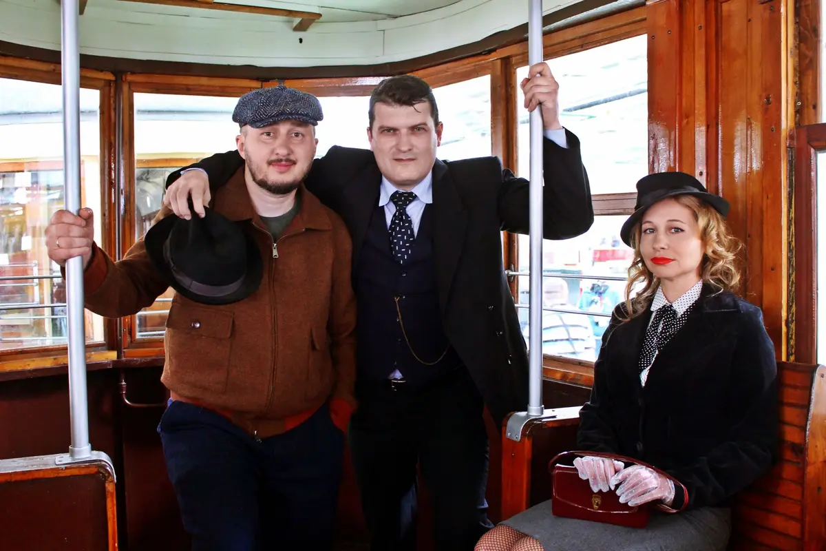 travelers in 1940s style clothes on a vintage tram, wartime jokes and home front humor