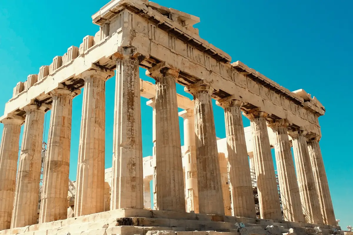 the Parthenon columns in Athens under a blue sky, Greek jokes about gods and philosophers
