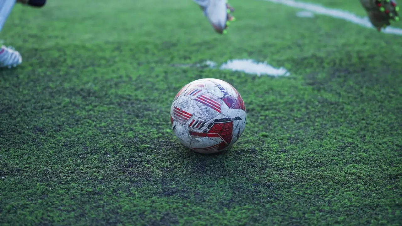a football on the grass of a pitch, image for arsenal joke gifts and captions