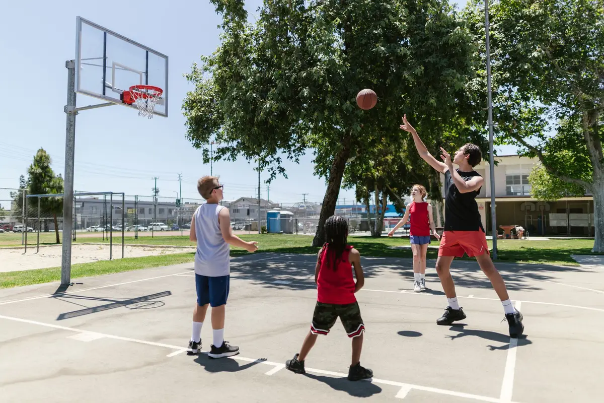 children playing basketball on a sunny outdoor court, basketball knock knock jokes for kids