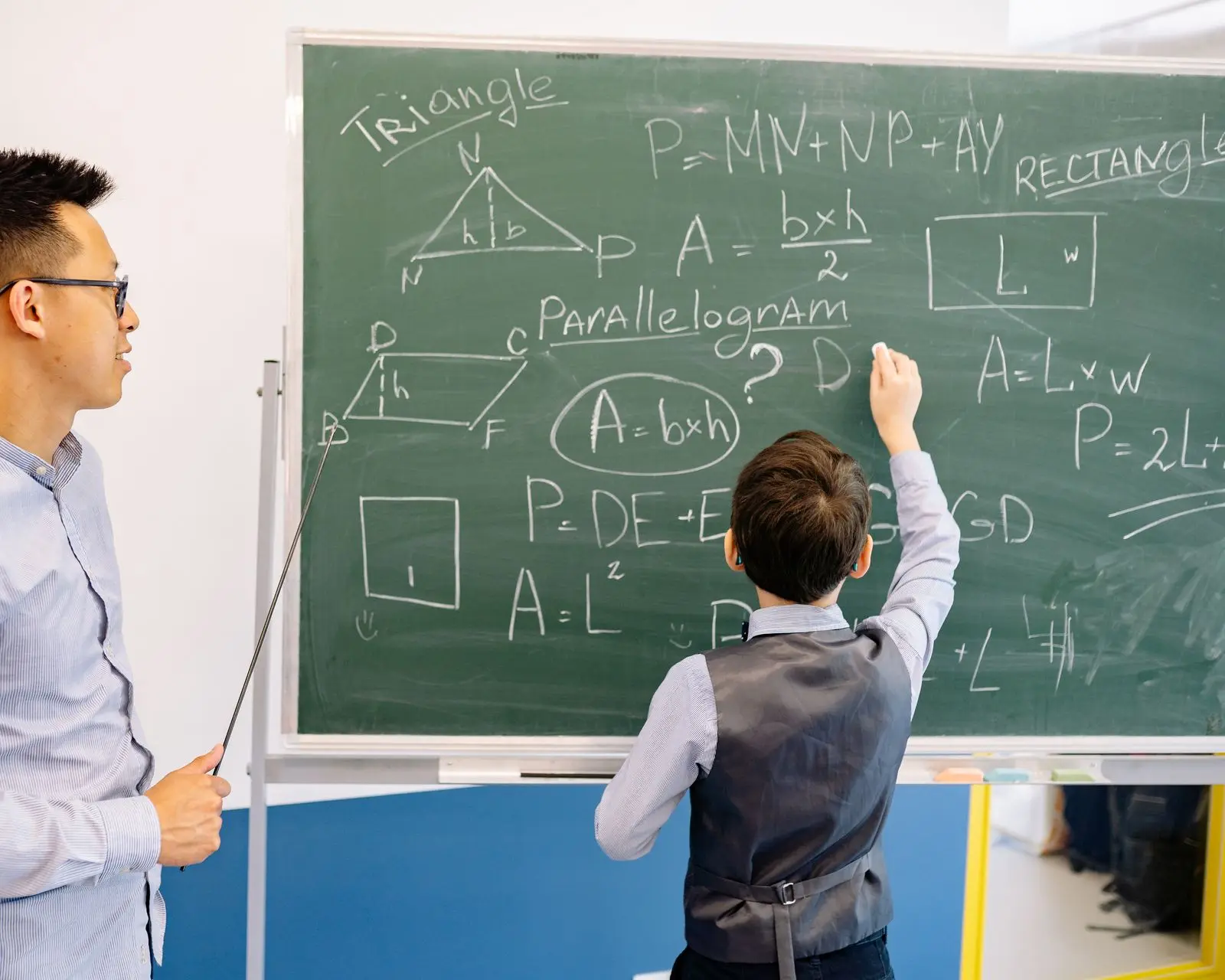 student solving a geometry problem on the chalkboard, image for fraction jokes and riddles