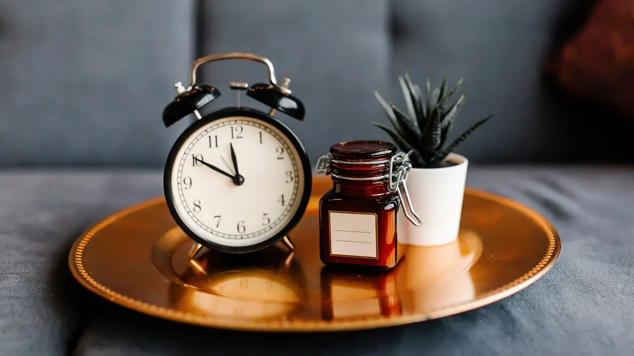 vintage alarm clock on a table, image for belated birthday jokes