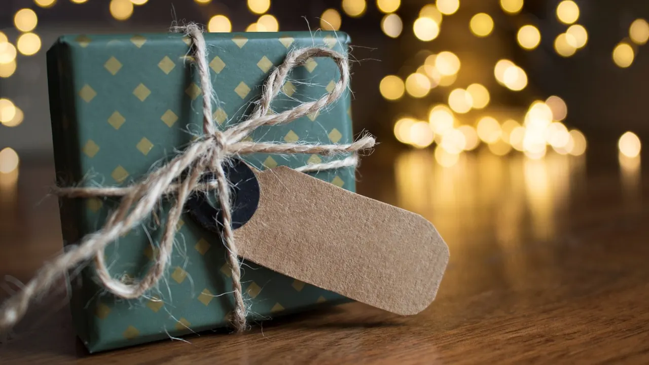 wrapped birthday present with a paper gift tag, image for birthday gift tag puns
