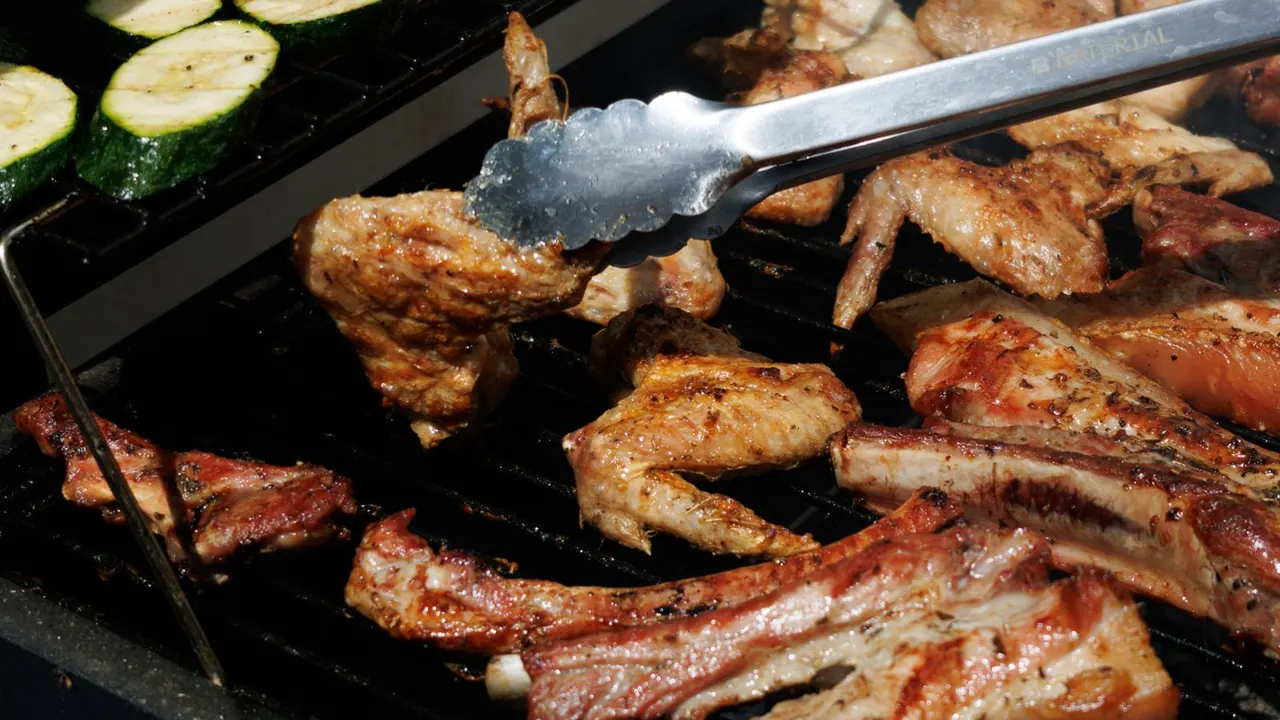 meat and zucchini sizzling on a backyard barbecue grill, image for dad birthday puns