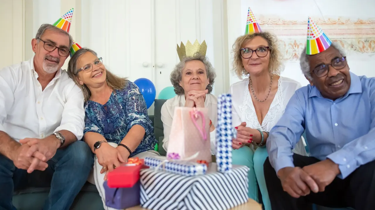 seniors in party hats laughing at a birthday party, image for birthday jokes for seniors