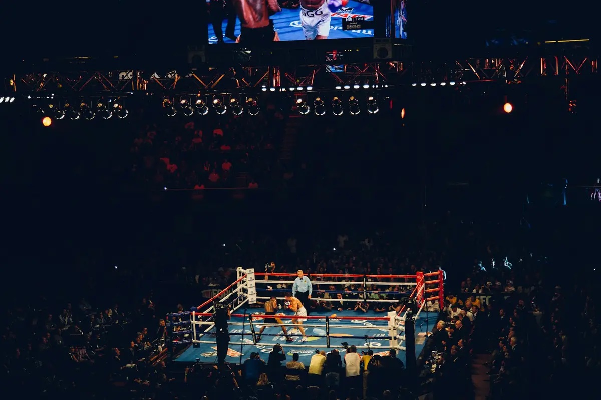 empty boxing ring under arena lights, setting for funny boxing lines