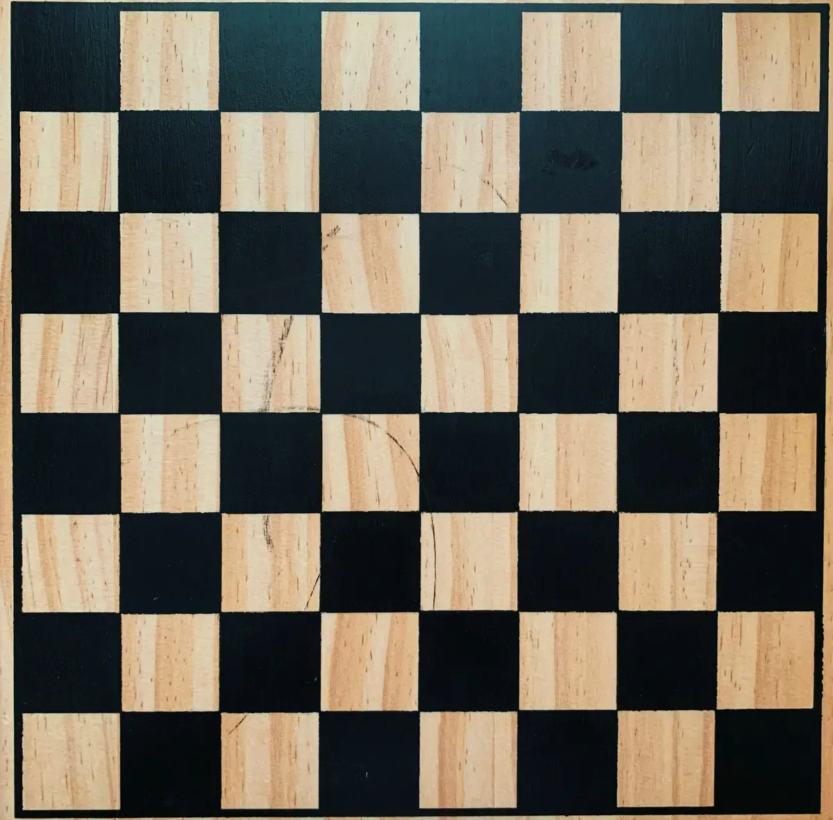 black and white chess board in a wooden frame set up for an opening, scene for checkmate and chess strategy puns