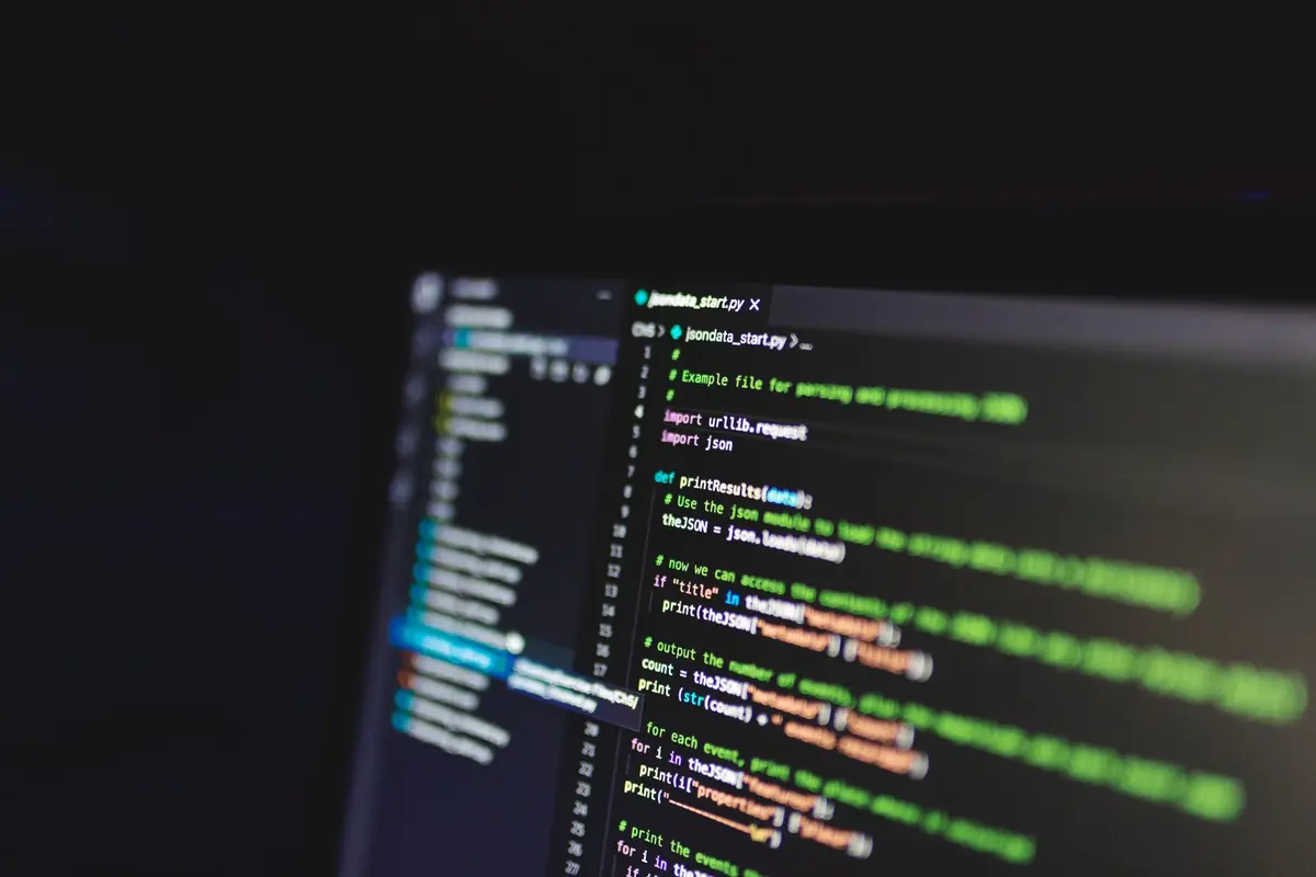 colorful programming code on a monitor in a dark room, funny coding jokes about Python and Java