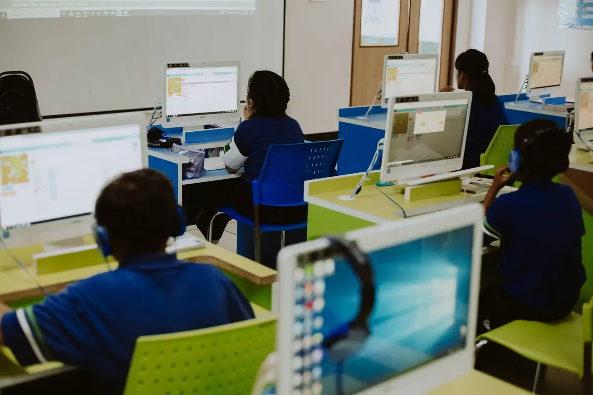children learning on computers in a classroom, computer jokes for kids