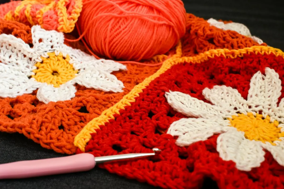 crocheted granny squares with yarn and a crochet hook, image for crochet puns