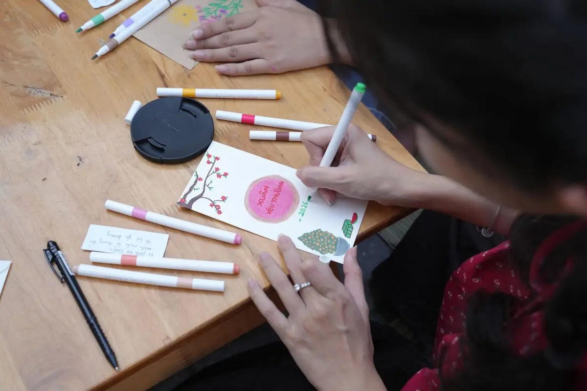woman drawing a handmade greeting card with colored markers, cute pun drawings for cards