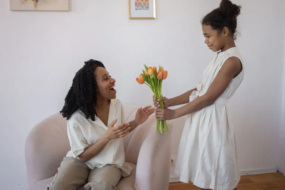 daughter surprising her mother with a tulip bouquet, flower puns for Mother's Day