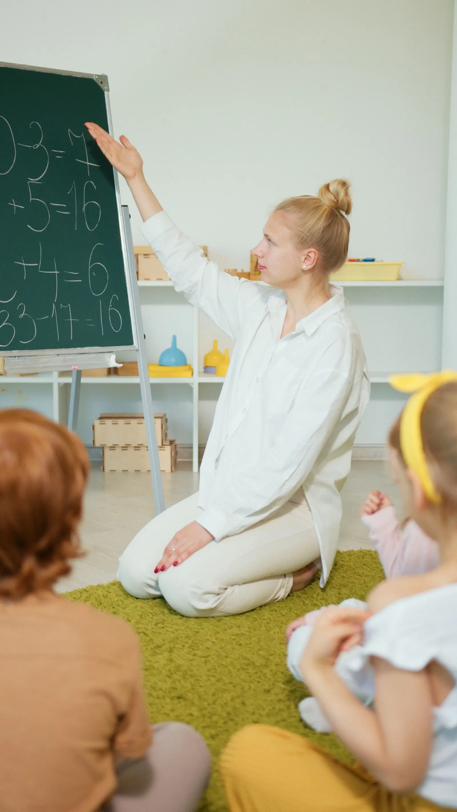teacher instructing children with math problems on a chalkboard, image for funny math dad jokes for teachers
