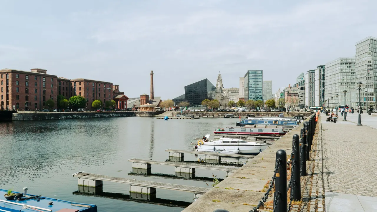 boats moored in a liverpool dock under a cloudy sky, image for everton new stadium jokes