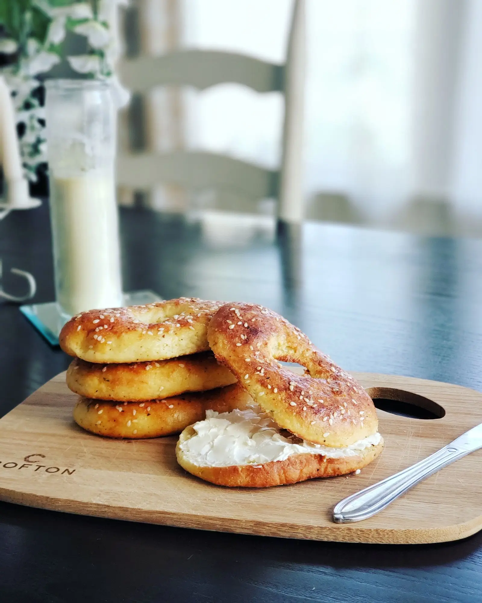 stack of bagels with cream cheese on a wooden board, image for bakery pun prints