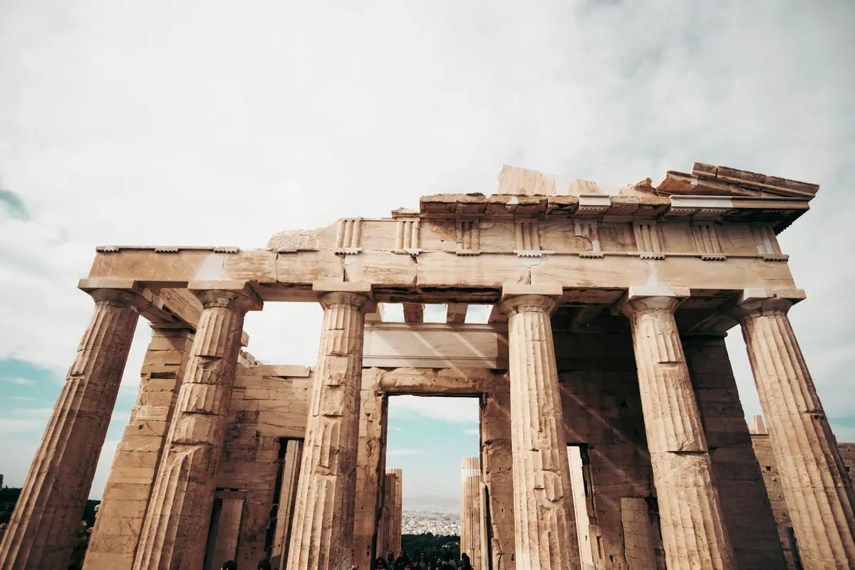 the ancient Parthenon ruins photographed from below against the sky, image for world wonders geography puns