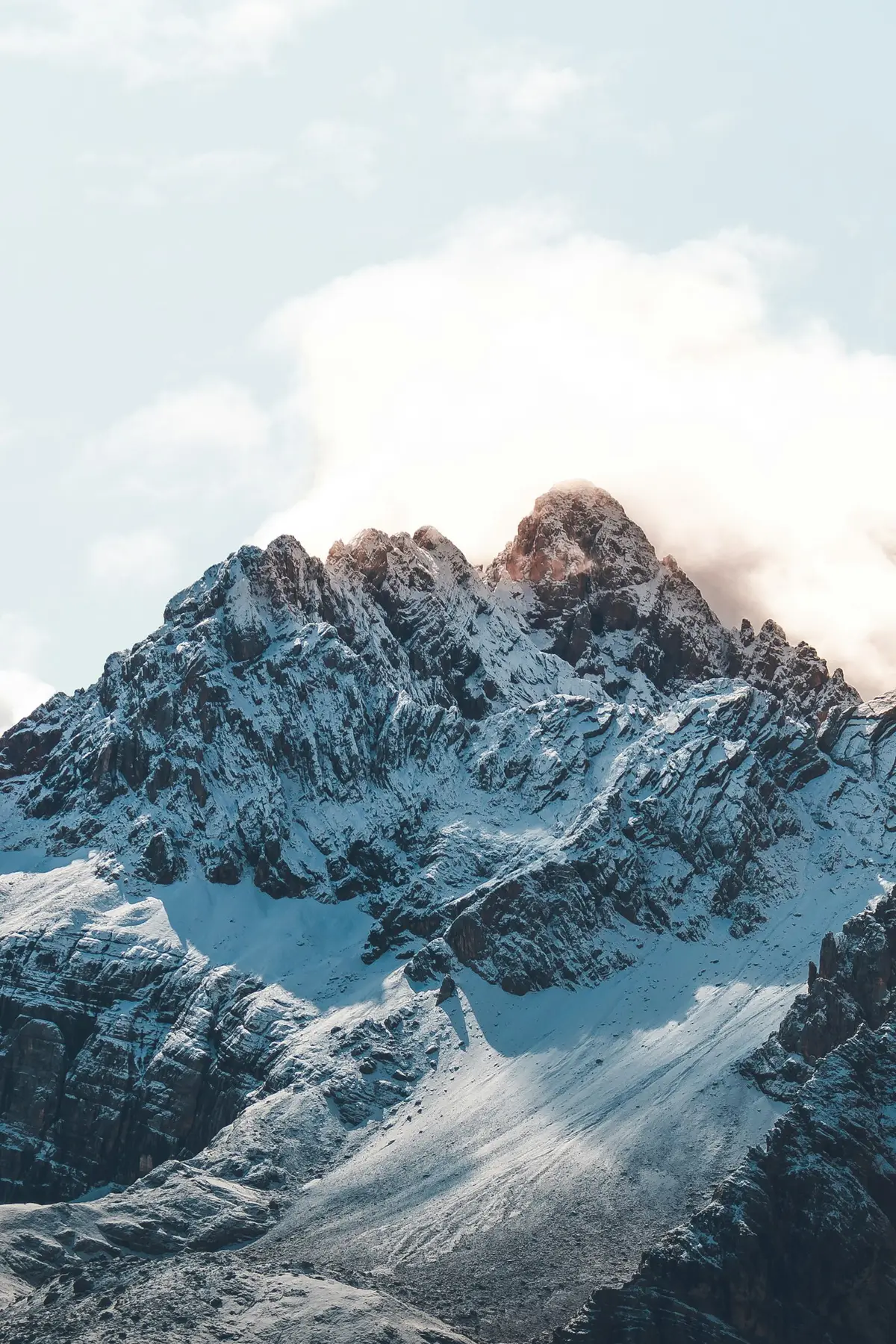 a snow-capped mountain range under daytime sky, image for mountain geography puns