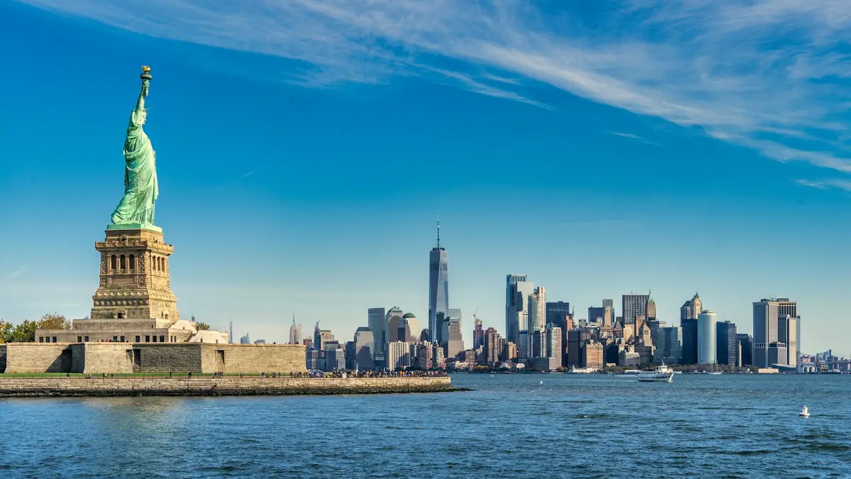the Statue of Liberty standing before the Manhattan skyline, image for American history puns