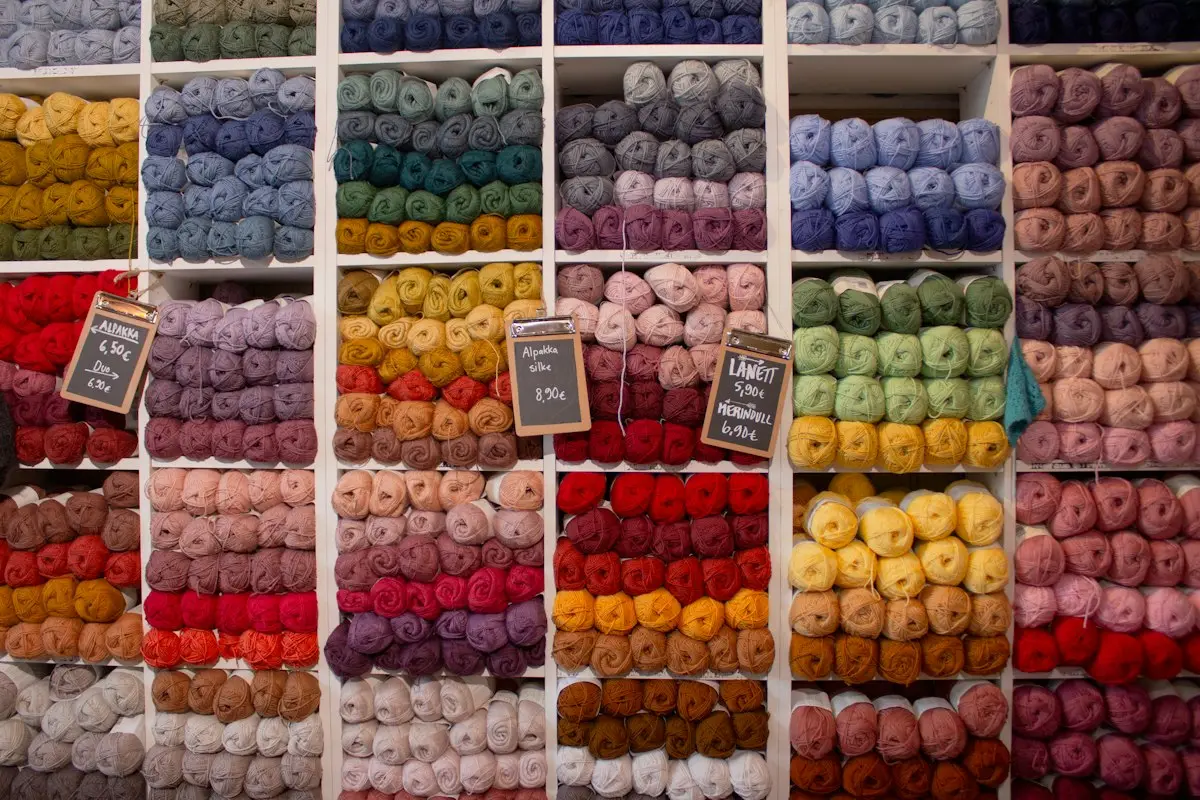 assorted color wool yarn skeins stacked together, image for wool puns