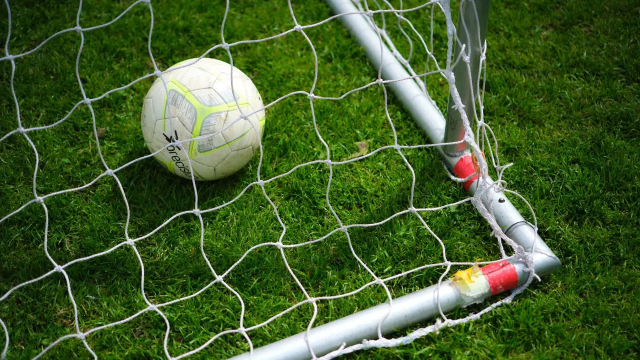 a football resting in a goal net, image for man city jokes about goals