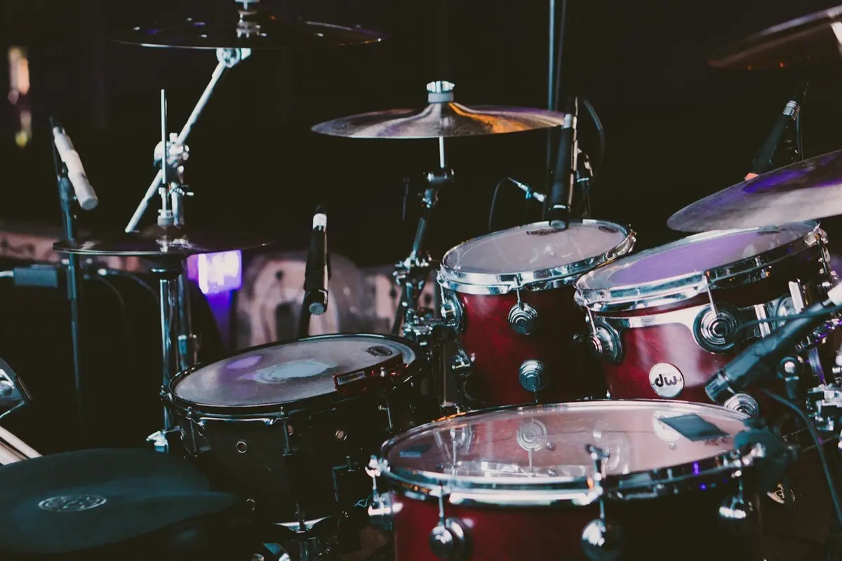 red drum set with cymbals in selective focus, image for drum puns and percussion jokes