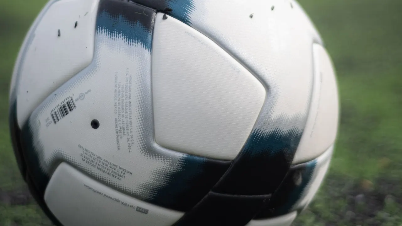 a white football on green grass in close-up, image for nottingham forest captions