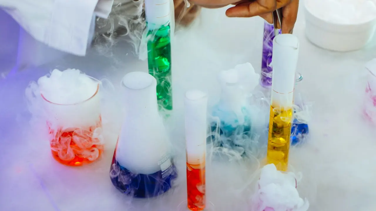 colourful liquids bubbling in lab glassware, image for organic chemistry lab glassware jokes