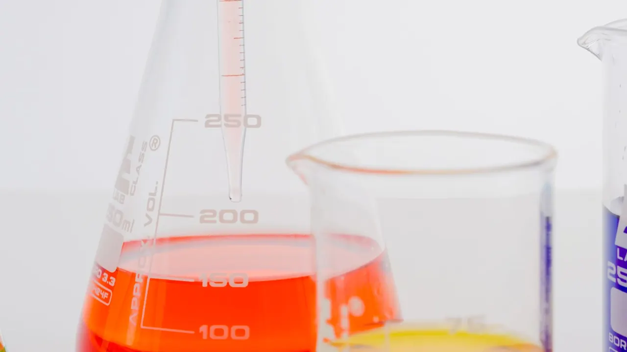 orange liquid in laboratory flasks and beakers, image for organic chemistry spectroscopy jokes