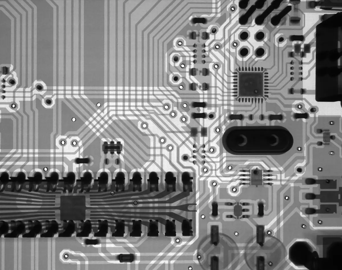 a close-up of a computer circuit board with electrical components, image for electricity and circuit physics puns