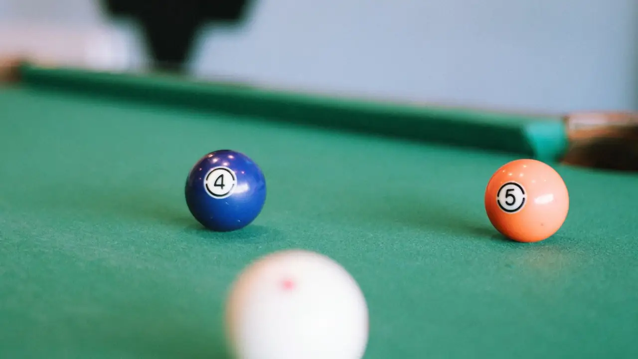 a white cue ball on a green pool table, image for pool table captions