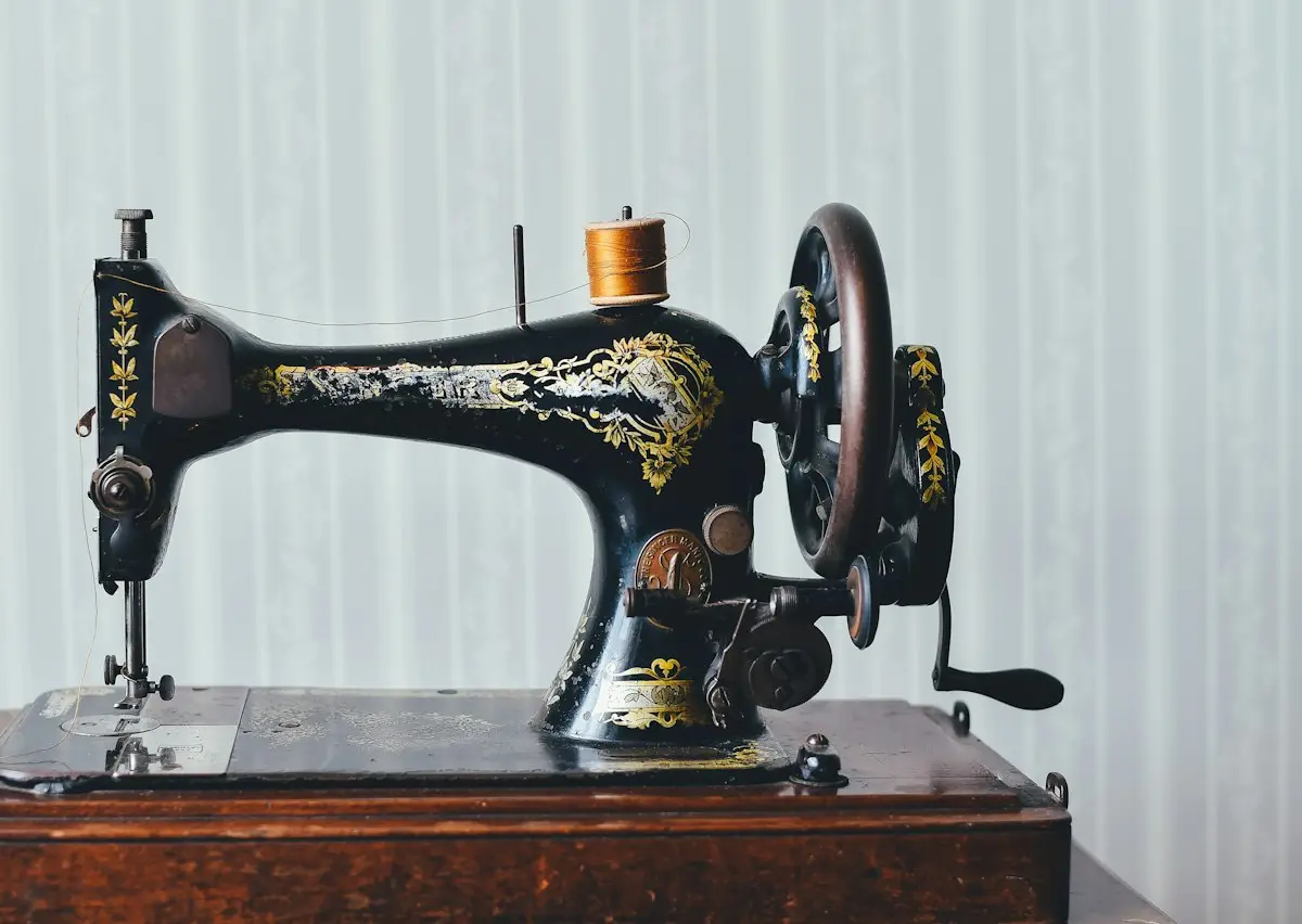 a black and yellow vintage-style sewing machine on a wooden table, image for sewing machine puns