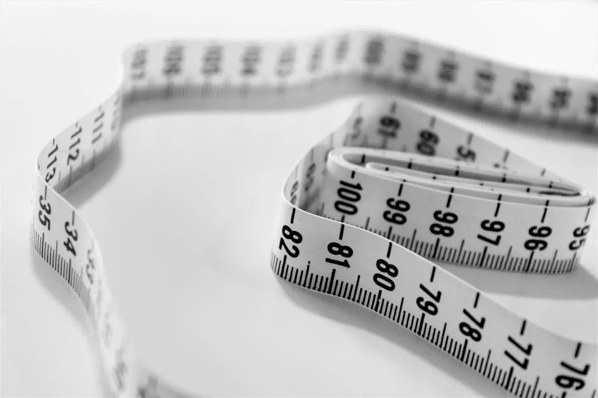a tailor's measuring tape in close-up selective focus, image for tailor and fashion puns
