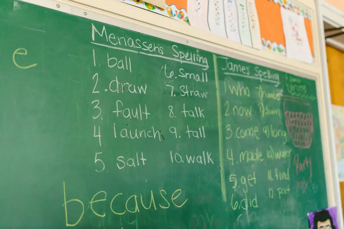 green classroom chalkboard with handwritten spelling words, math and science teacher appreciation jokes