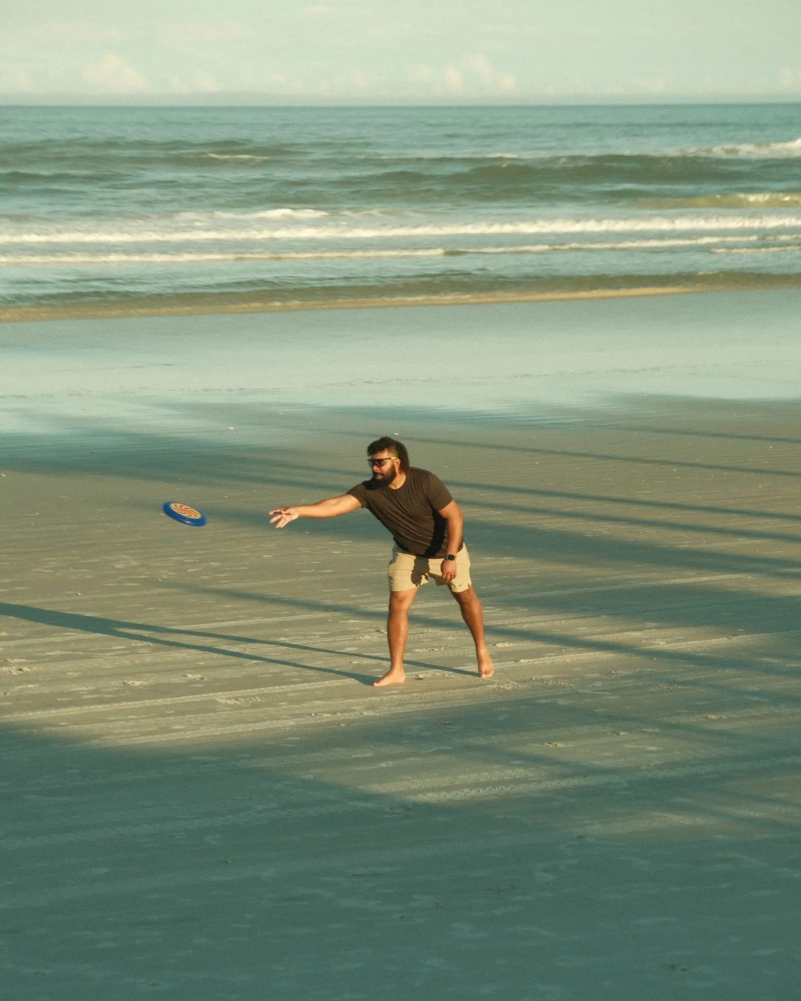 man playing frisbee on a sunny beach, image for beach ultimate frisbee jokes