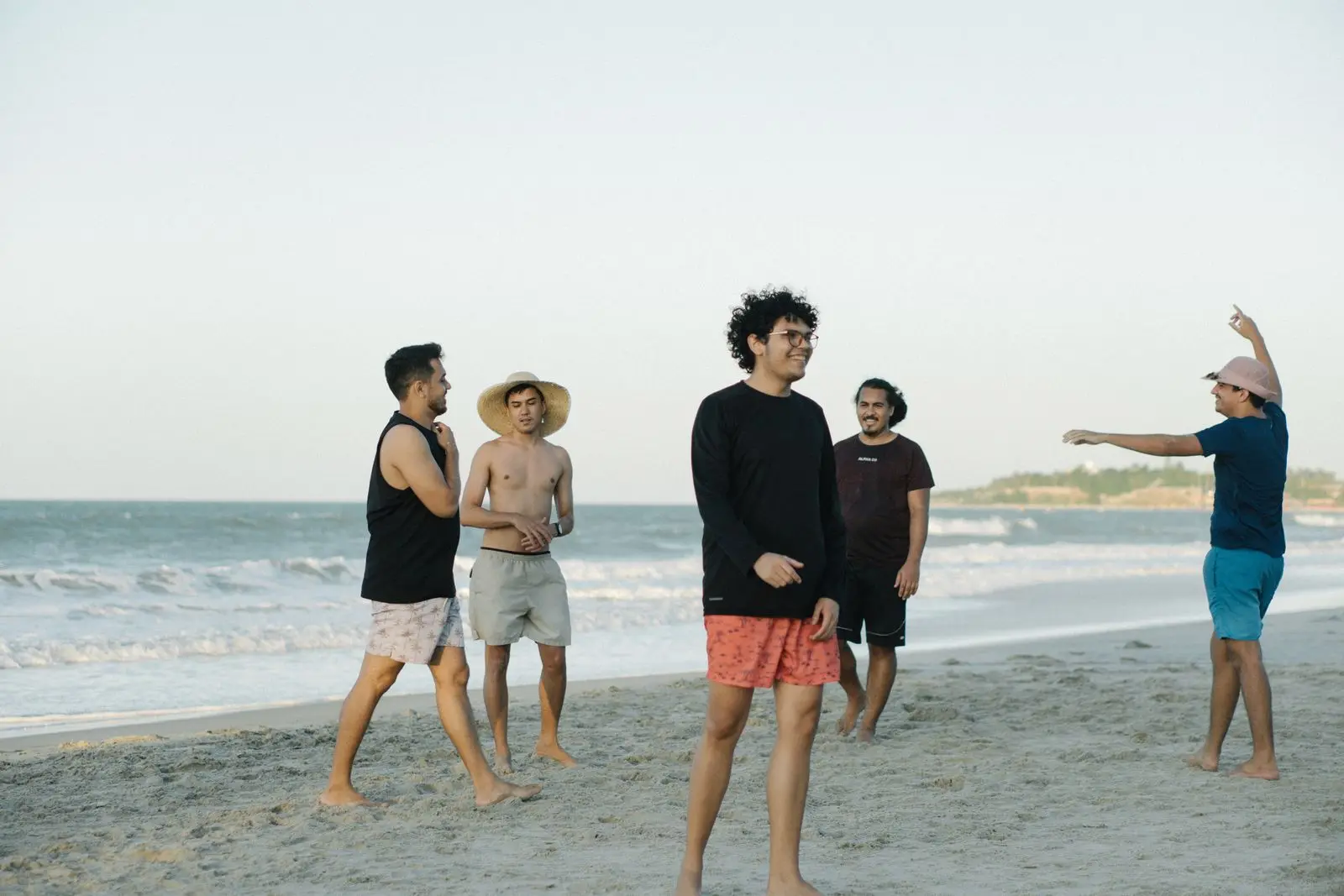 group of men playing frisbee on the beach, image for best ultimate frisbee disc jokes