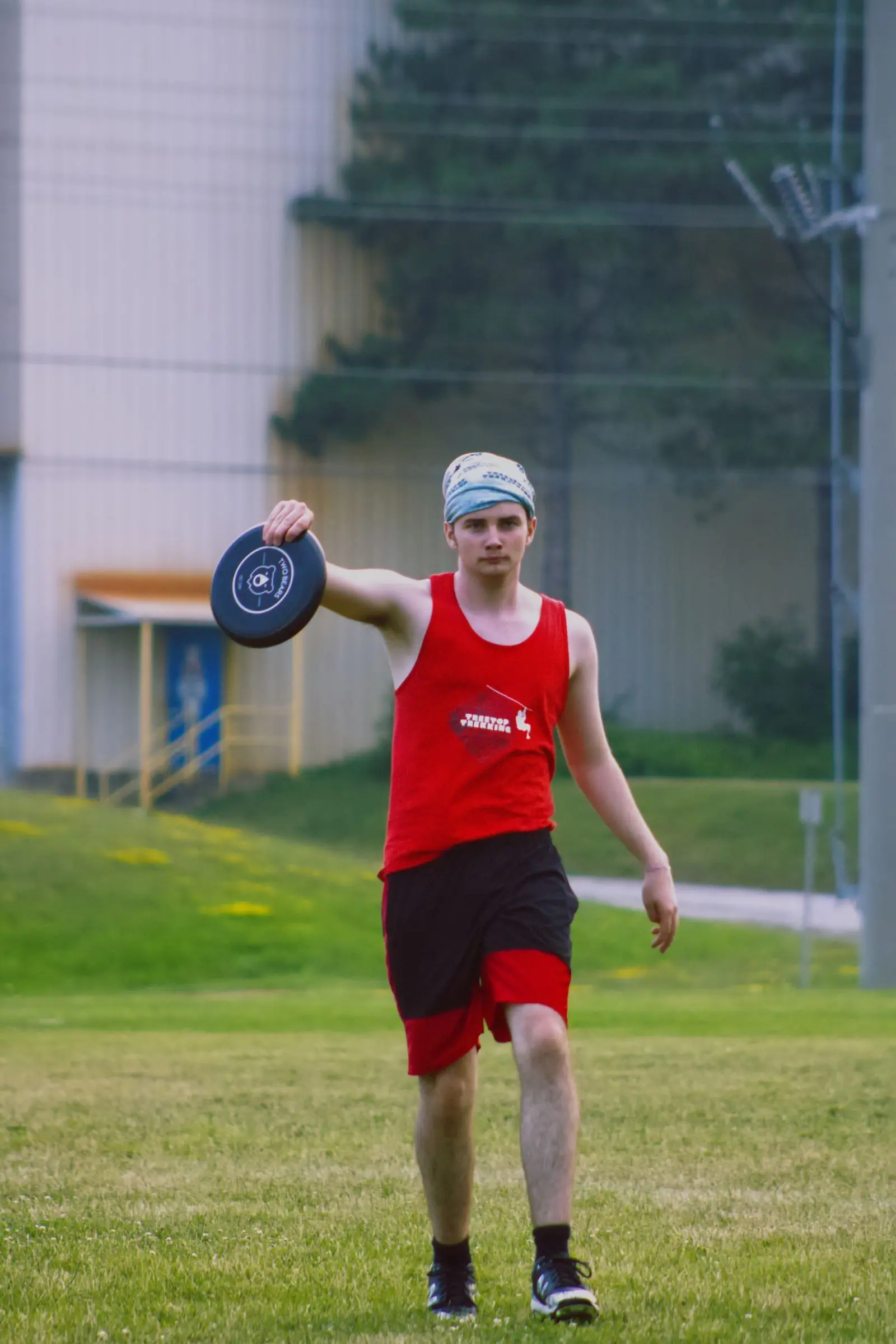 young man playing frisbee in a park, image for ultimate frisbee jokes one liners
