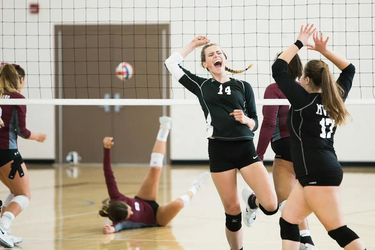 women's volleyball team playing on an indoor court, image for volleyball puns team names