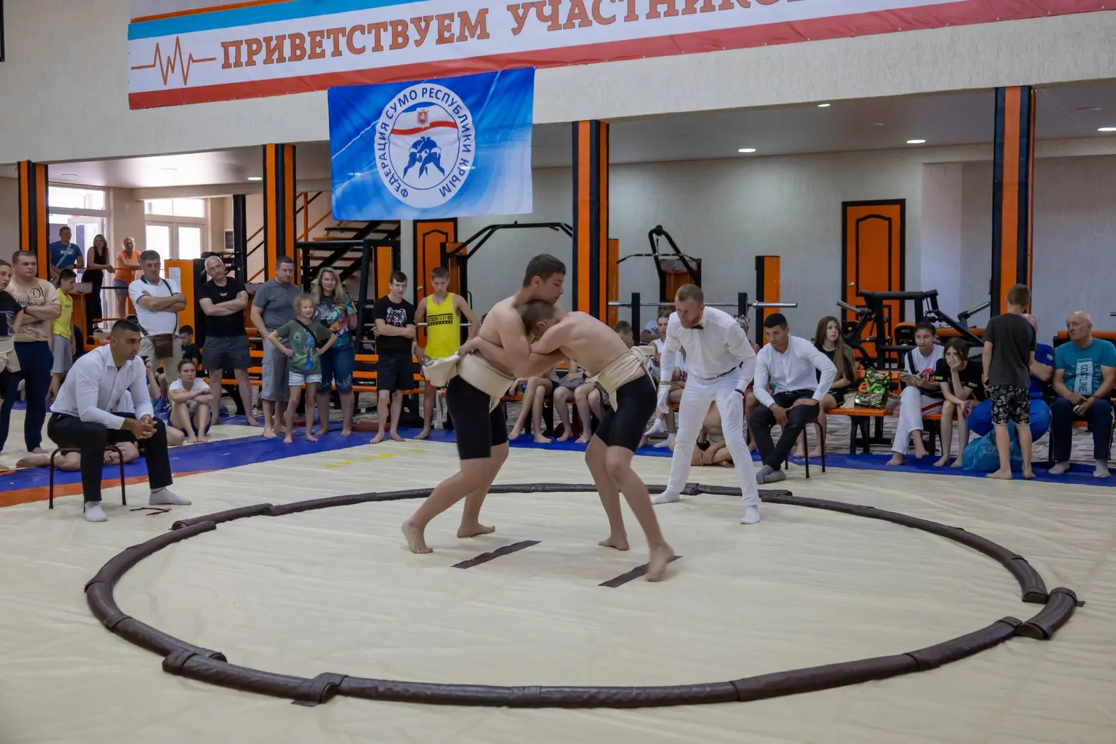 young men in a wrestling match with spectators watching, image for WWE dad jokes