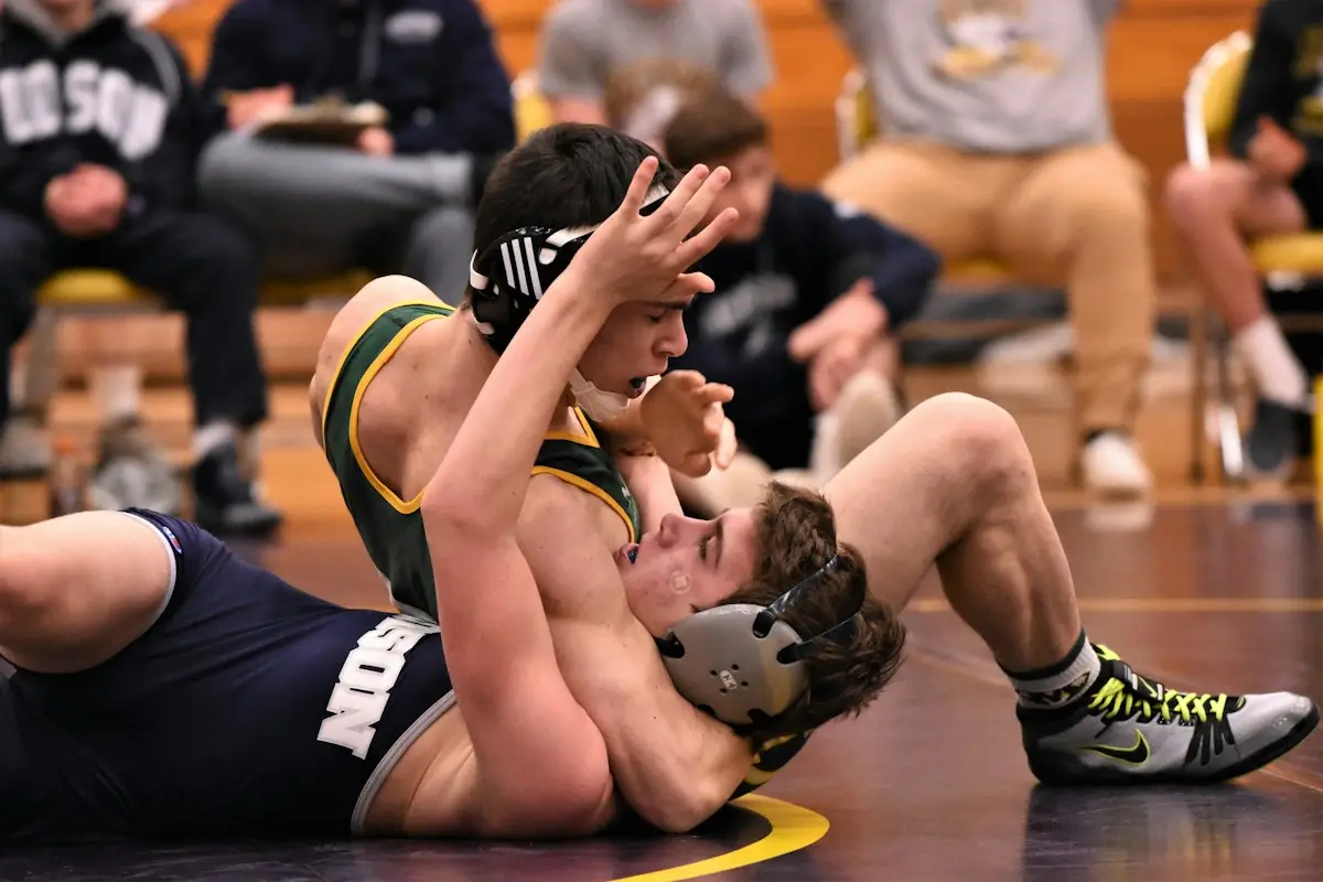 wrestler controlling an opponent on the mat, scene for wrestling puns one liners